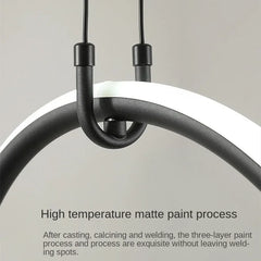 Modern pendant light with black metal fixture on a neutral background