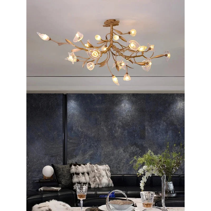 Modern chandelier in a stylish living room with dark walls and decorative elements.
