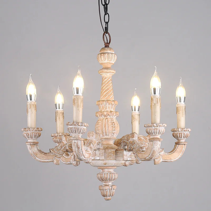 Front view of a distressed wood candelabra chandelier with six candle-style lights against a plain gray background.