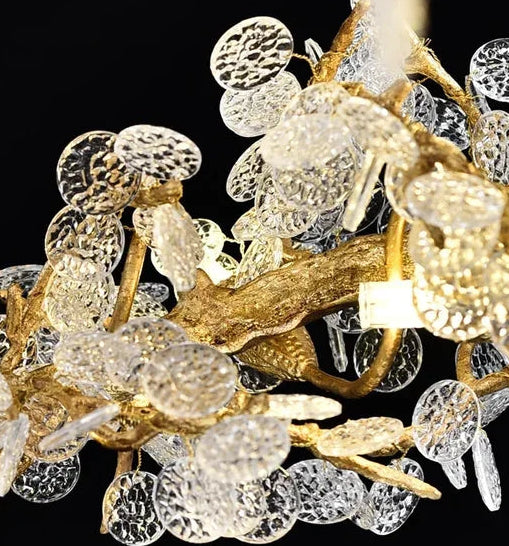 Close-up of a decorative chandelier with gold and crystal elements on a black background