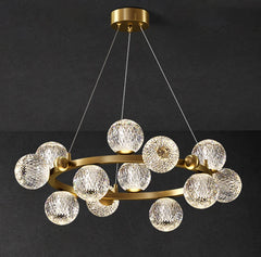 Chandelier with gold frame and clear glass balls on a black background