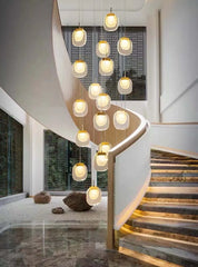 Modern staircase with decorative pendant lights in a stylish interior setting.
