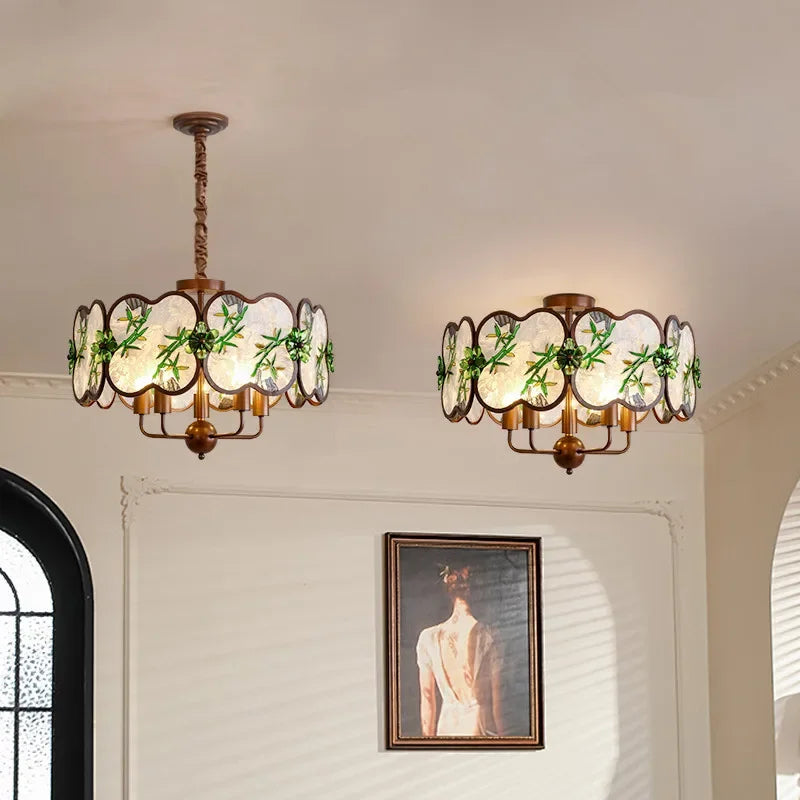 Two matte bronze floral pendant lights with scalloped glass shades hanging from the ceiling.