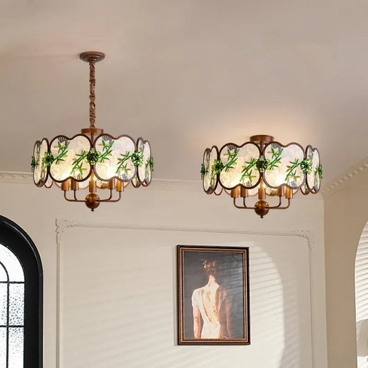 Two matte bronze floral pendant lights with scalloped glass shades hanging from the ceiling.