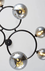 Modern chandelier with spherical metal lights on a white background