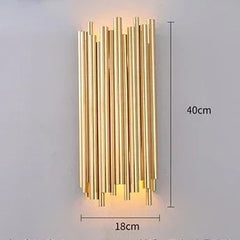 Gold cylindrical wall light fixture with dimensions on a gray background