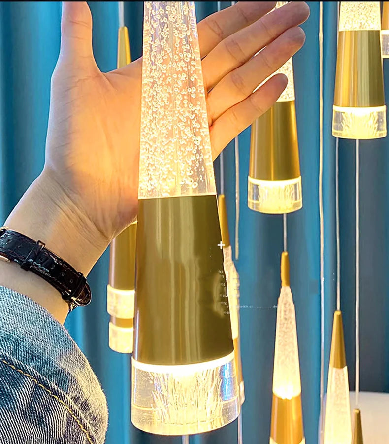 Hand holding a decorative lamp with a blue curtain background