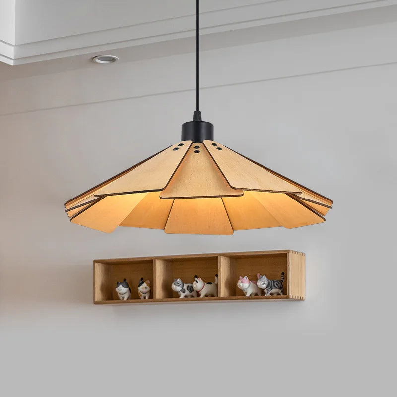 Close-up of a tiered geometric pendant light made of natural wood, illuminated from within.