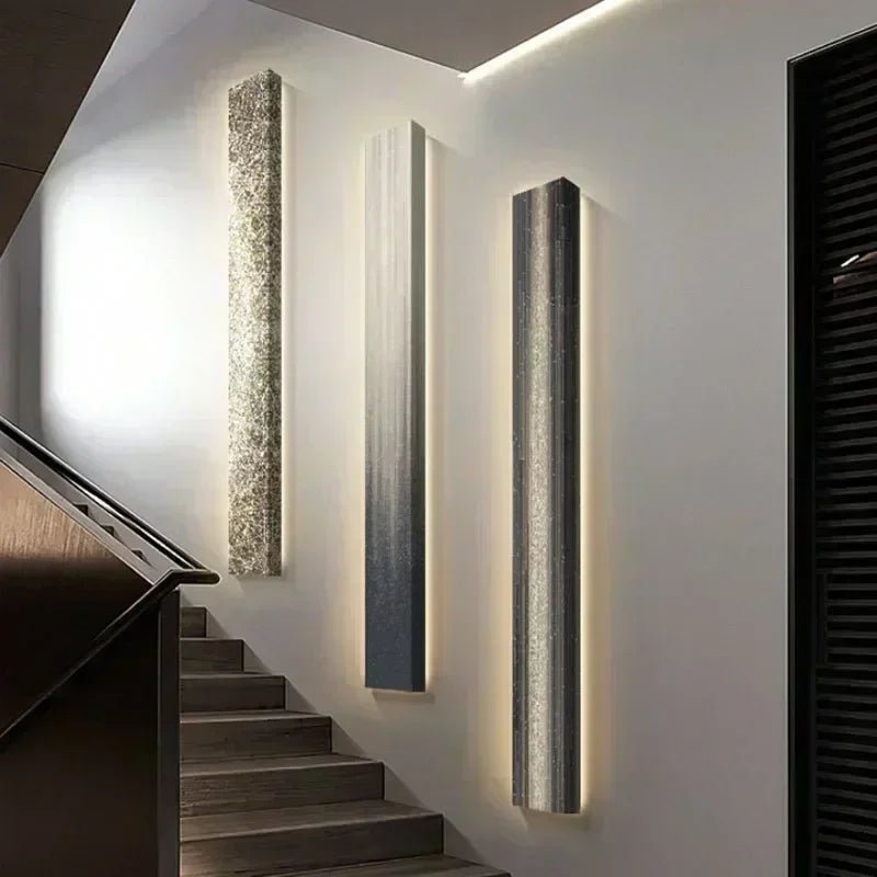 Modern wall-mounted light fixtures on a staircase wall