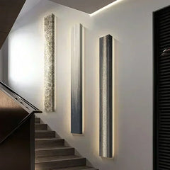 Modern wall-mounted light fixtures on a staircase wall