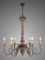 Close-up view of the distressed wood and iron candle-style chandelier, highlighting its ornate details.
