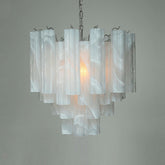 White frosted glass tube chandelier with a chrome frame, tiered design, and chain suspension.