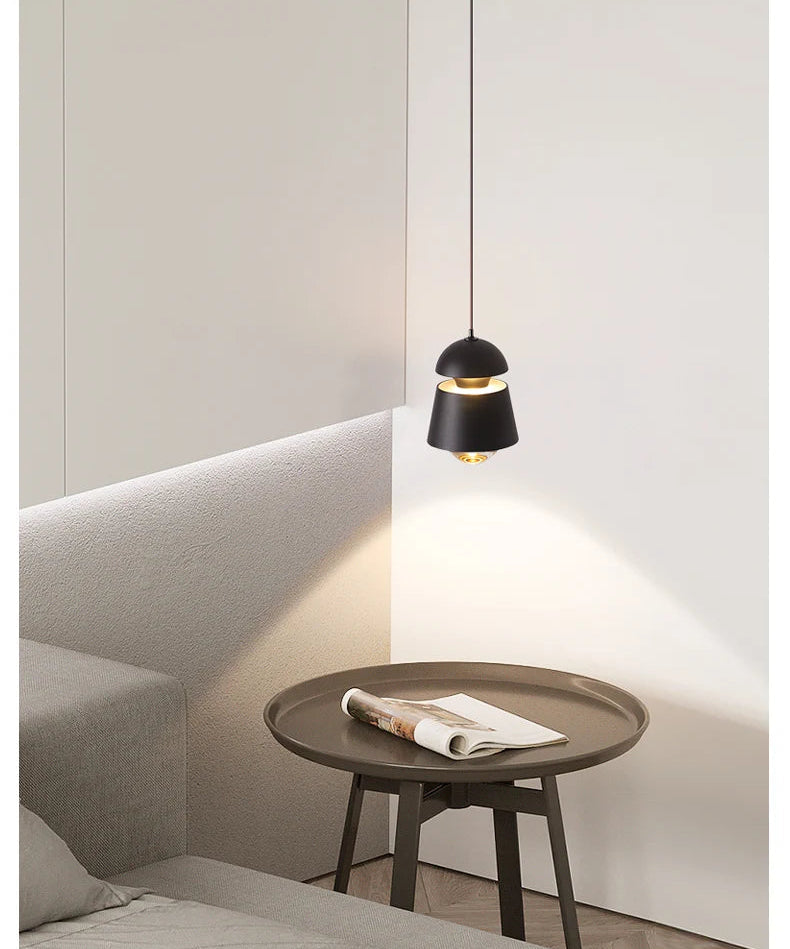 Modern pendant light fixture in a minimalistic room setting.