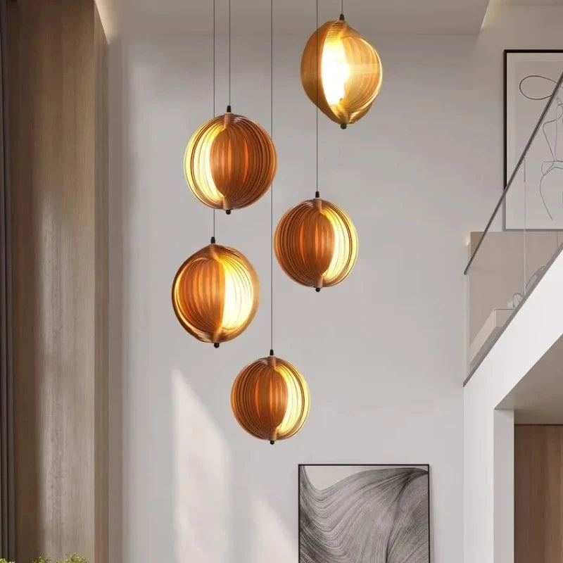 Modern pendant lights hanging in a room with neutral walls and abstract art.