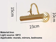 Gold wall lamp with dimensions and material details on a beige background