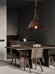 Dining area with a wooden table and chairs, featuring a rustic pendant light.
