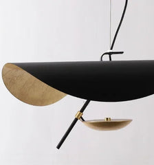Modern pendant light with black and gold design on a white background