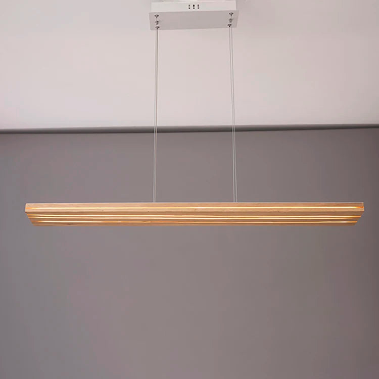 Modern pendant light fixture hanging against a plain background