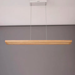 Modern pendant light fixture hanging against a plain background
