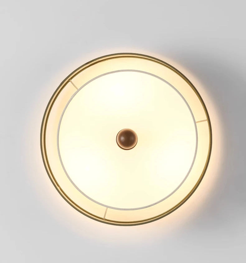 Round ceiling light fixture on a white ceiling