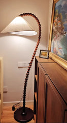 Floor lamp with wooden bead design in a room setting