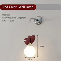 Red color wall lamp with heart-shaped design on a white background