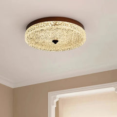 Ceiling light fixture in a room with beige walls and a white window frame.