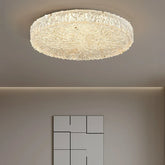 Round gold textured resin flush mount ceiling light illuminating a room