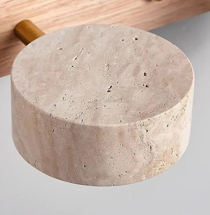 Round concrete block with a wooden handle on a light gray background