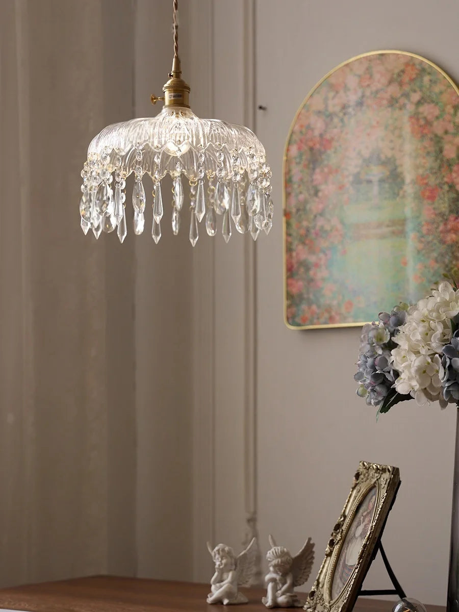Crystal pendant light fixture in a room with decorative elements.