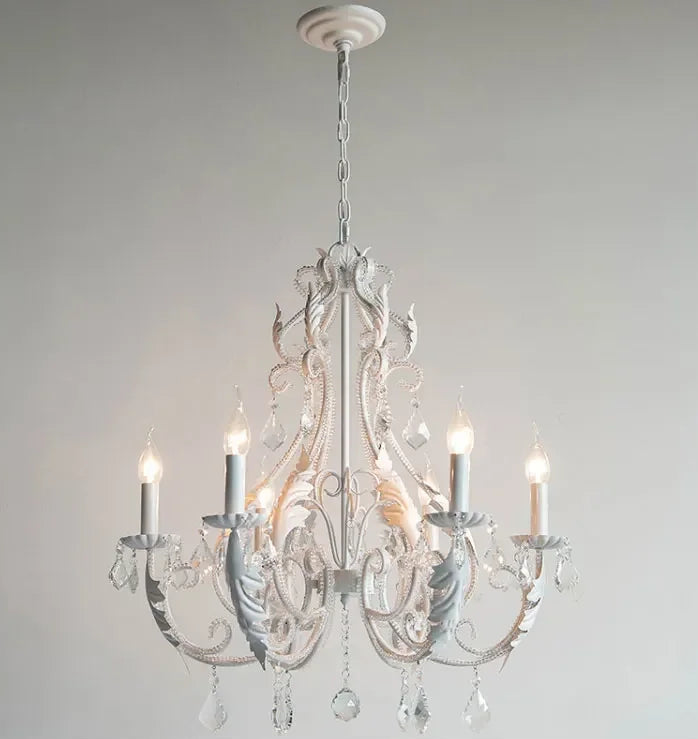 White chandelier with crystal accents on a plain background