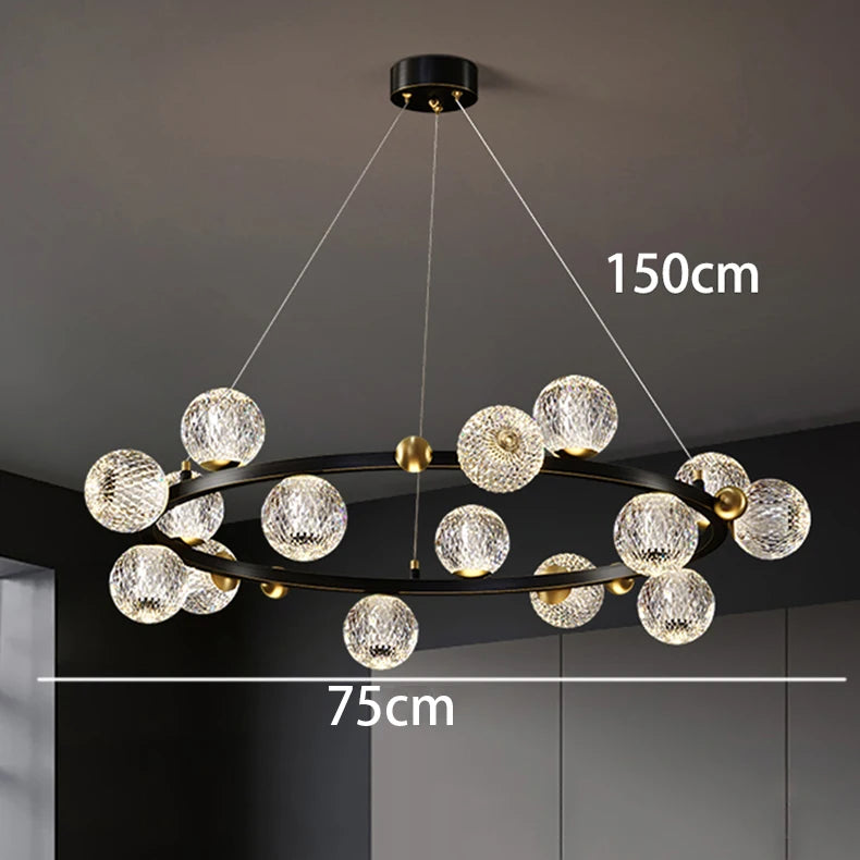 Modern chandelier with crystal-like spherical lights on a dark ceiling.