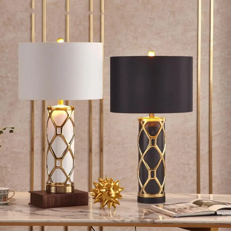 Two table lamps with decorative bases on a marble surface.