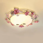 Pink rose bud floral design semi-flush ceiling light with frosted glass diffuser against a plain ceiling