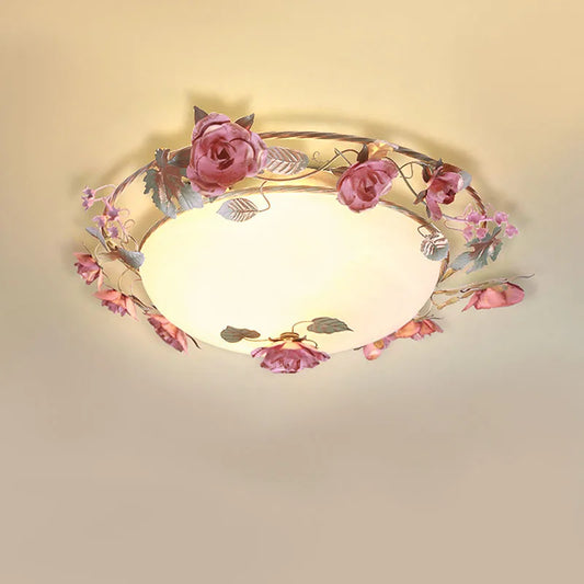 Pink rose bud floral design semi-flush ceiling light with frosted glass diffuser against a plain ceiling