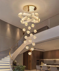 Chandelier hanging above a staircase in a modern interior setting