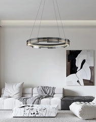 Modern living room with a chandelier, sofa, and abstract painting.