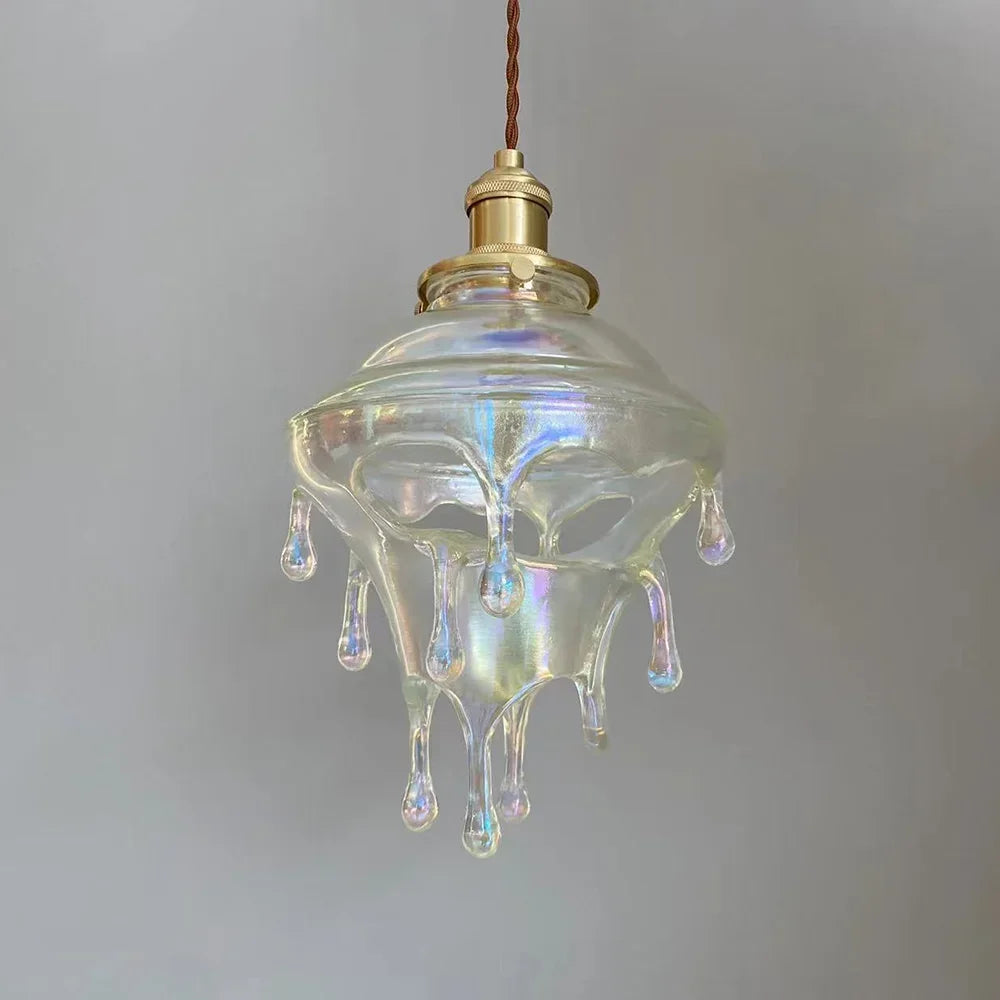 Glass pendant light with a unique design on a plain background