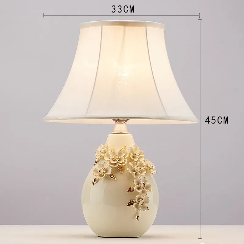 Decorative table lamp with floral design and measurements on a gray background