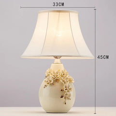 Decorative table lamp with floral design and measurements on a gray background