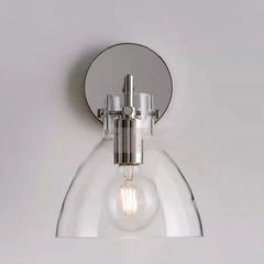 Silver-finished wall sconce with a clear glass dome shade and visible LED bulb.