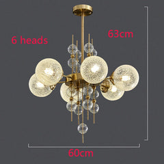 Chandelier with six glass globe lights on a dark background, showing dimensions.