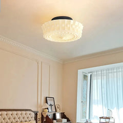 A corner view of a room showing the white frosted glass drum semi-flush ceiling light.