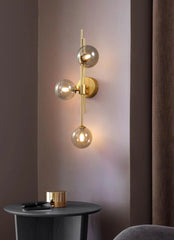Modern Gold Brass Sconce with Three Frosted Globe Shades
