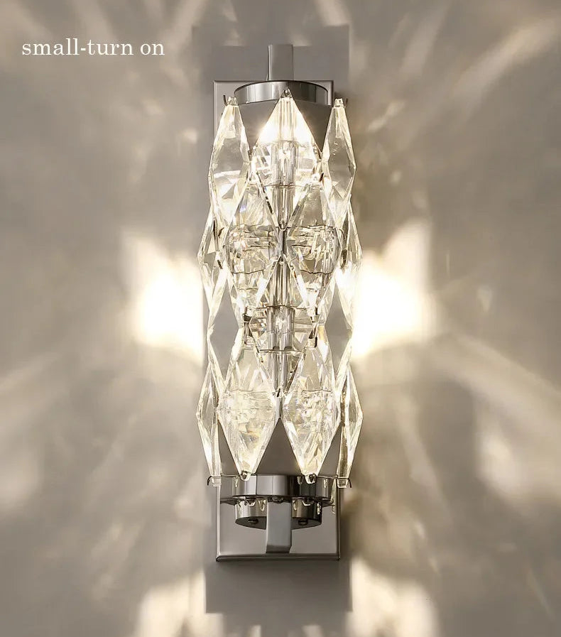 Wall-mounted light fixture with crystal design on a neutral background