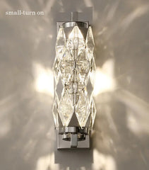 Wall-mounted light fixture with crystal design on a neutral background