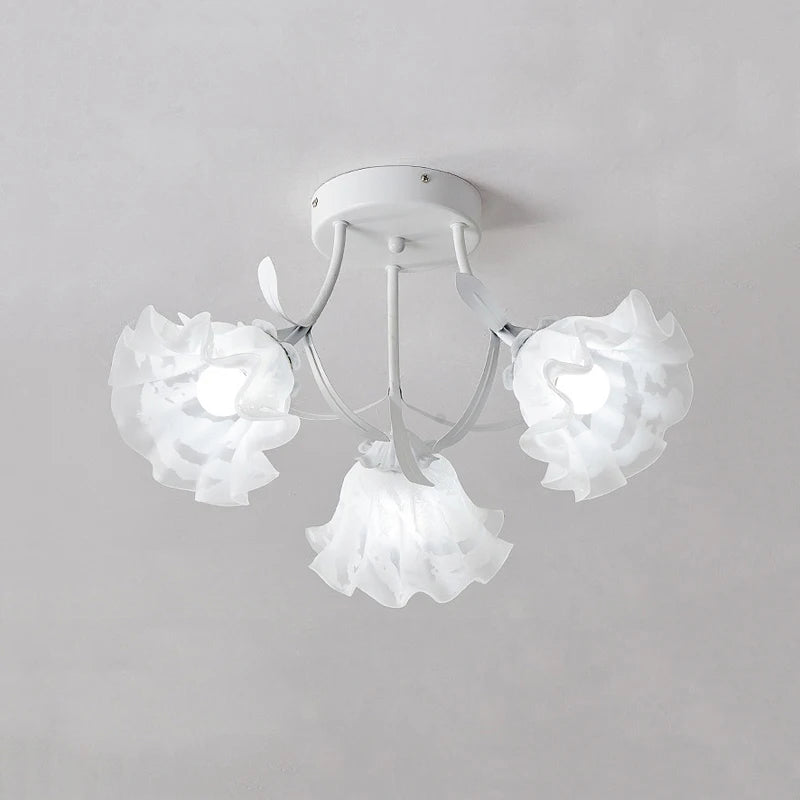White semi-flush mount ceiling light with three ruffled white flower-shaped glass shades and white metal stem details.