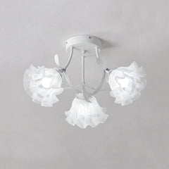 White semi-flush mount ceiling light with three ruffled white flower-shaped glass shades and white metal stem details.