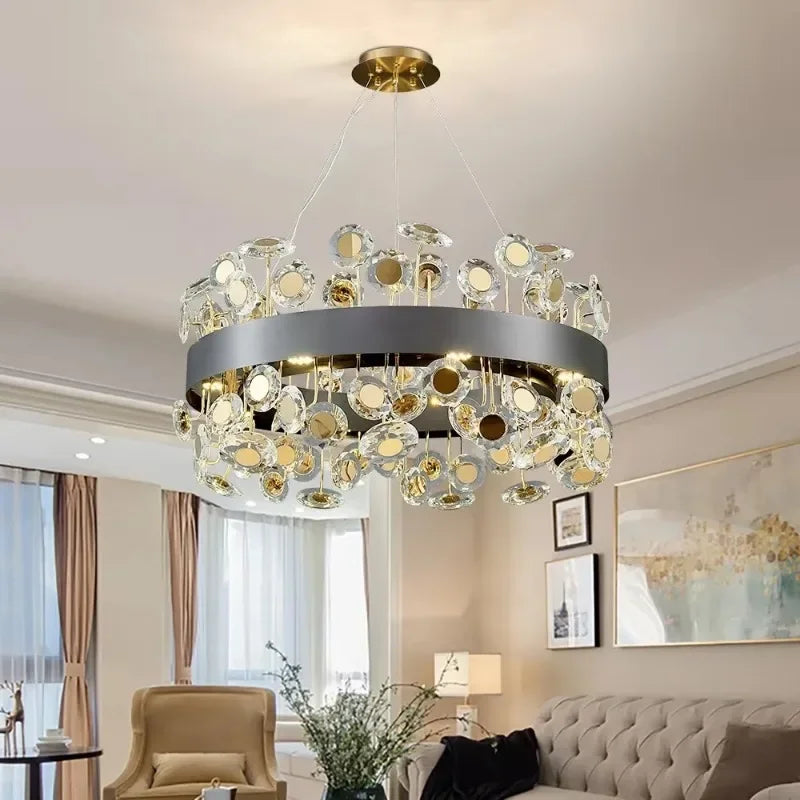 Round dark gray chandelier with cascading clear and gold-toned crystals, suspended from the ceiling in a living room.