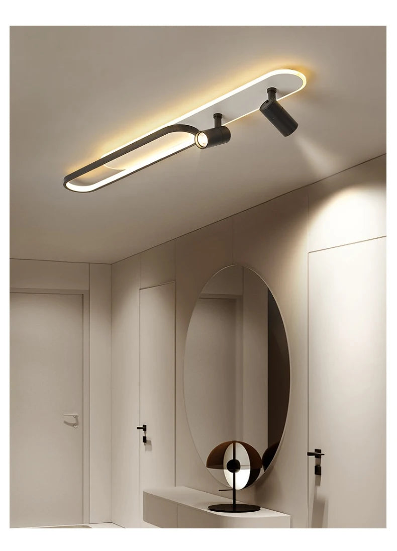 Modern ceiling light fixture in a minimalistic room with a mirror.